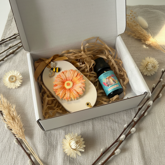 Gerbera daisy eco resin room diffuser gift set in a white gift box with golden paper shred